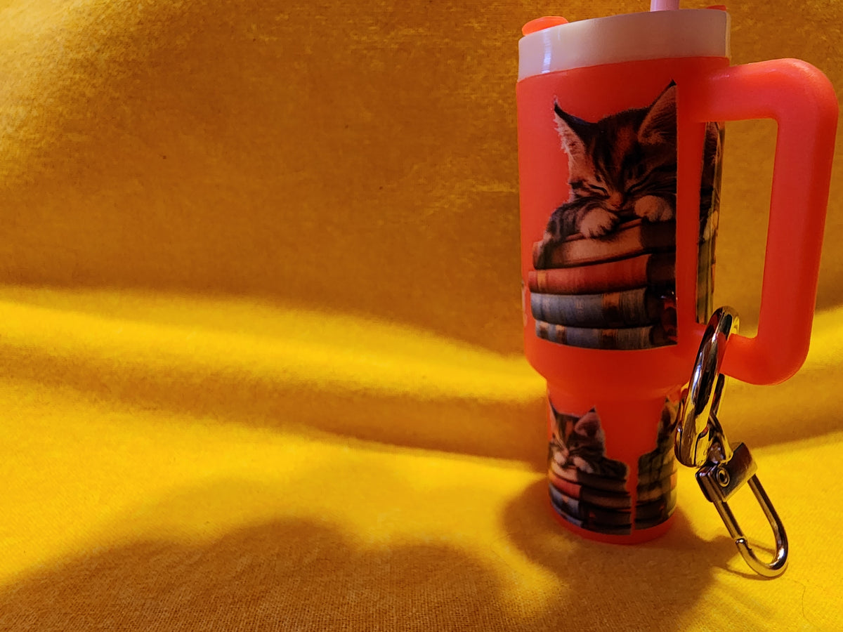 Sleeping kittens on books chapstick holder