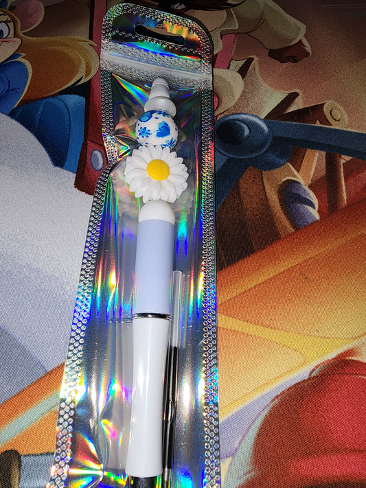 White daisy with blue pen.