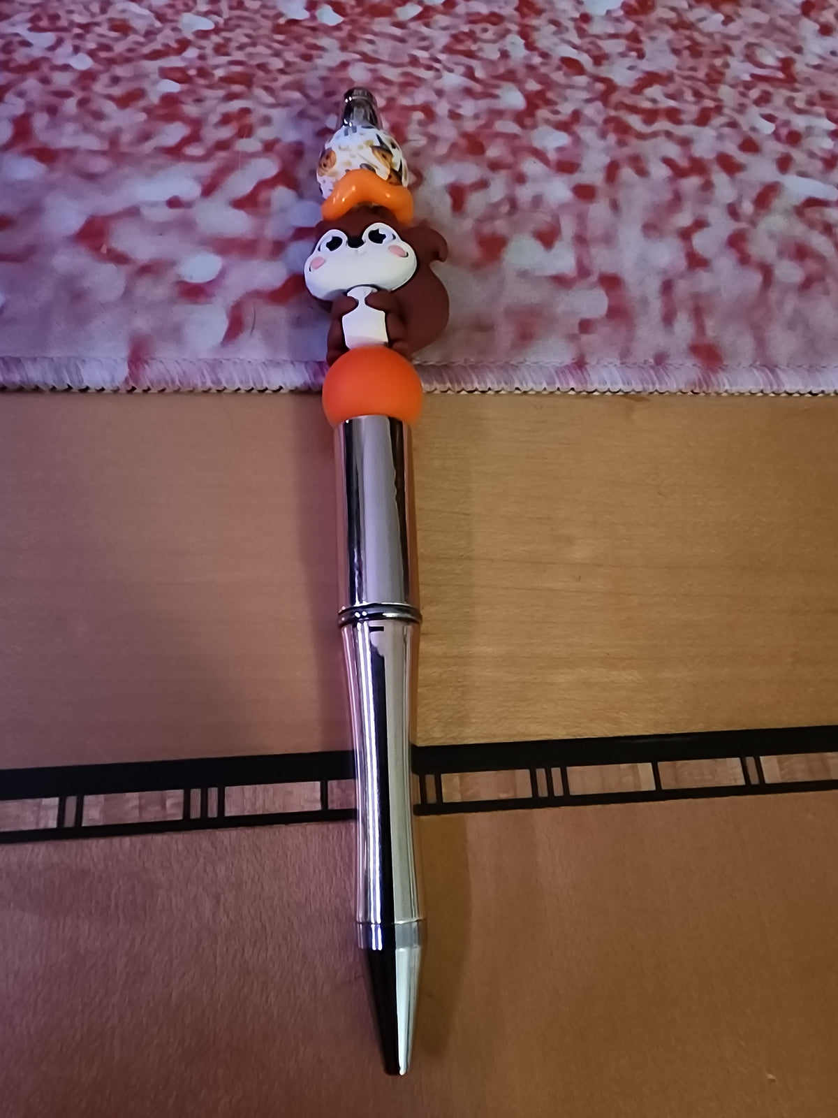 Squirrel pen on a shiny gold base