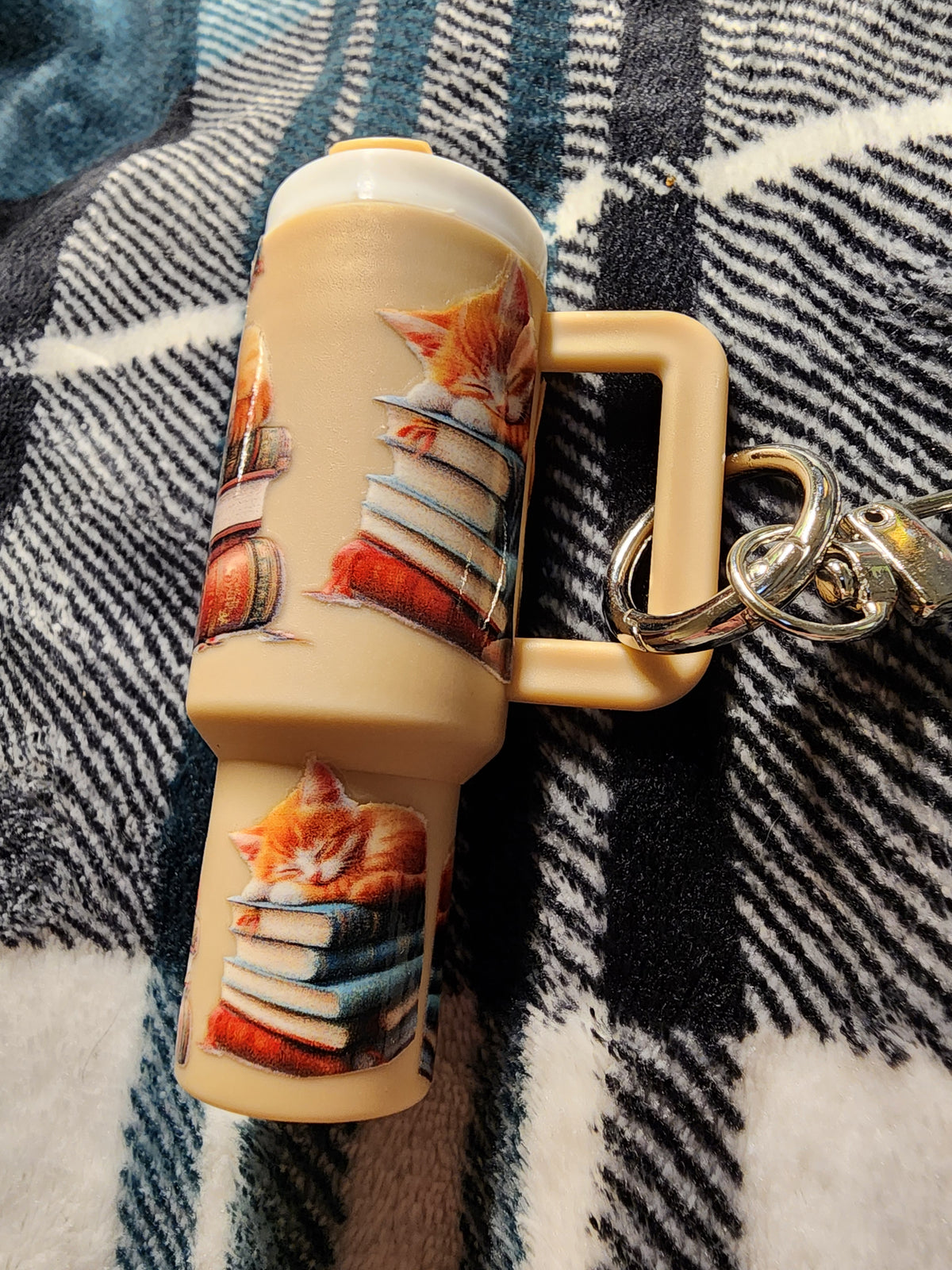 Tan bottle kittens sleeping on books chapstick holder