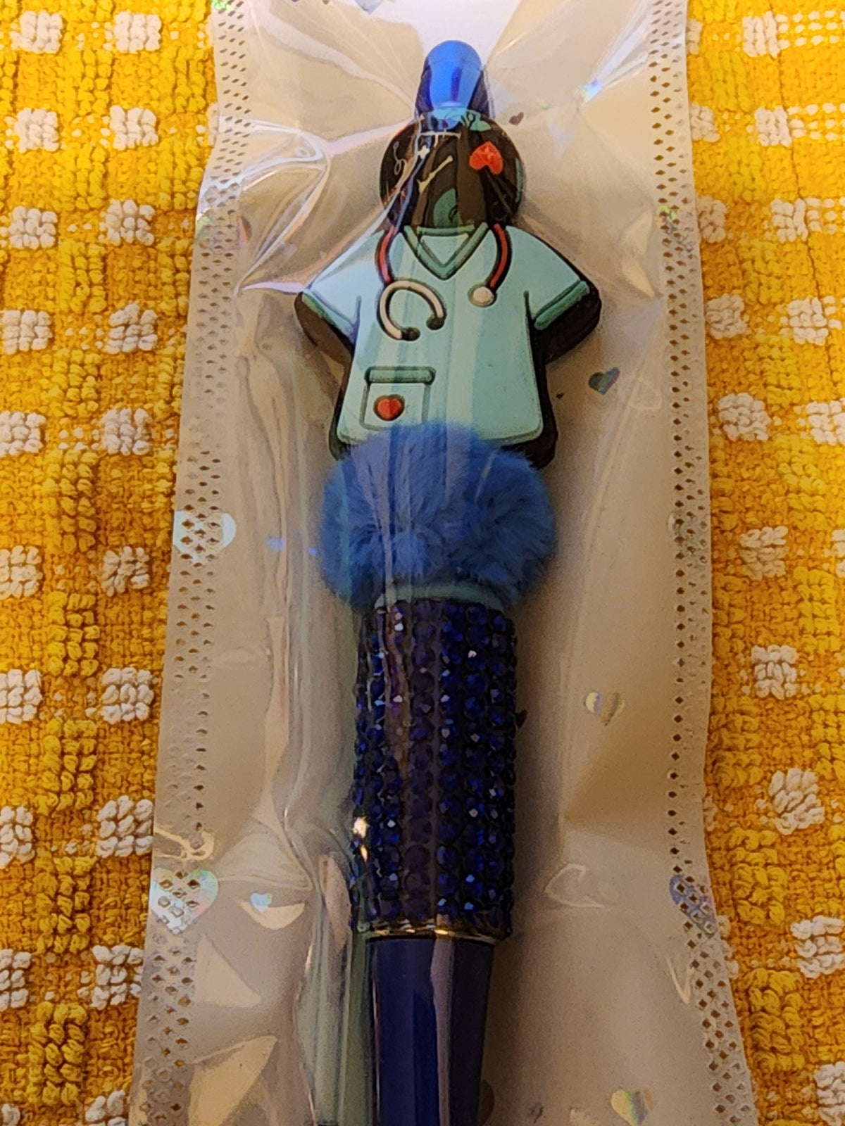 Dark blue scrub pen with fluffy bead