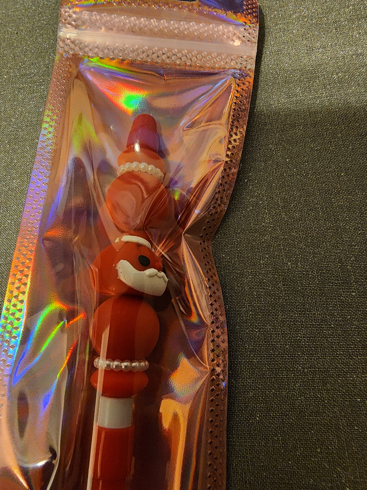 Red santa dumpling on a red mechanical pencil