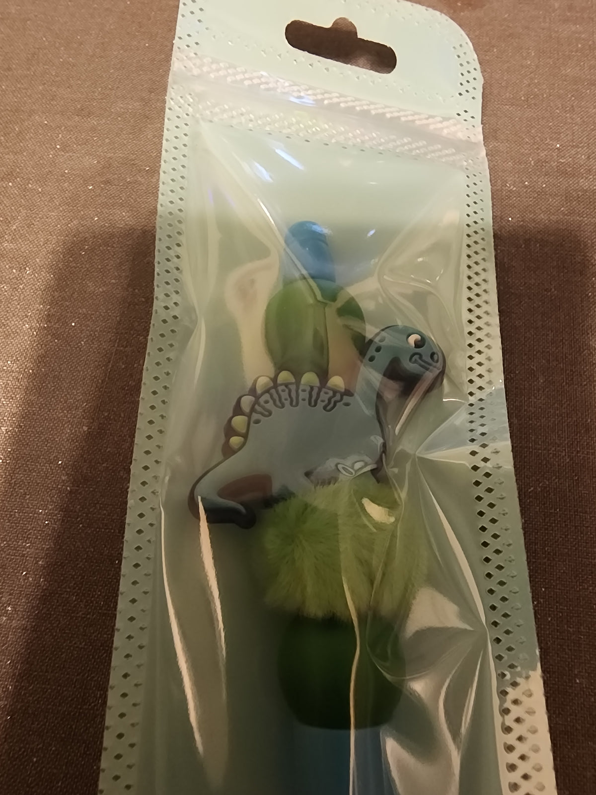 Dinosaur pen with green fuzzy bead