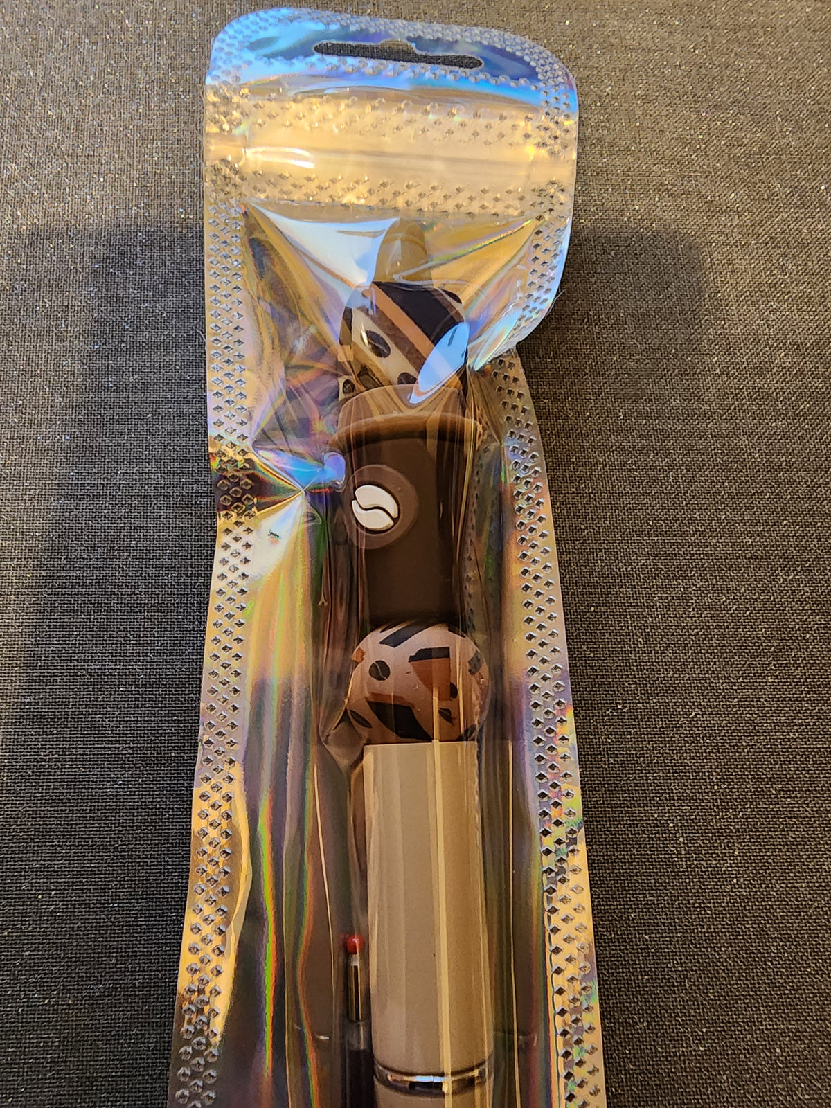 Dark Brown coffee cup on a tan pen