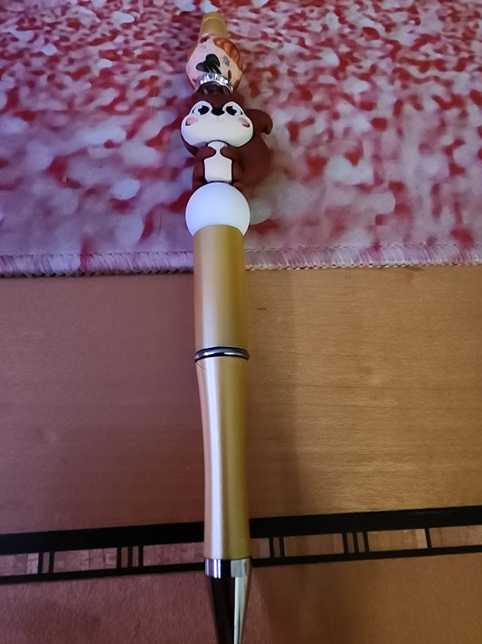 Squirrel pen with a pumpkin bead on a golden matte pen