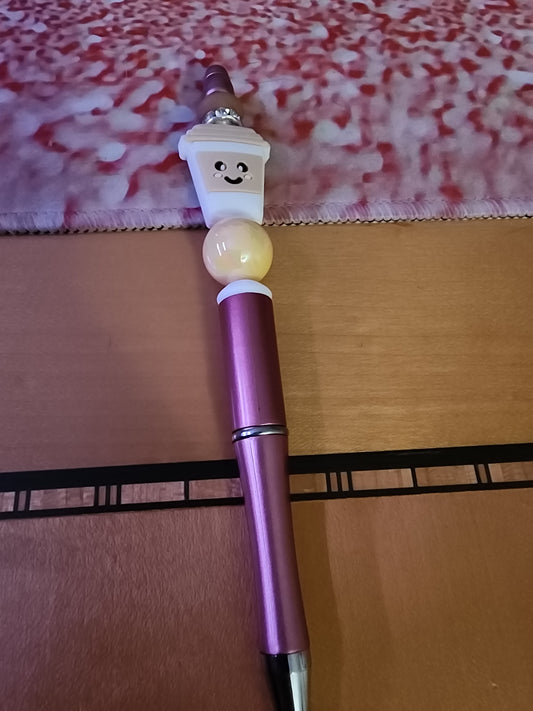 Tan coffee cup on a rose gold pen