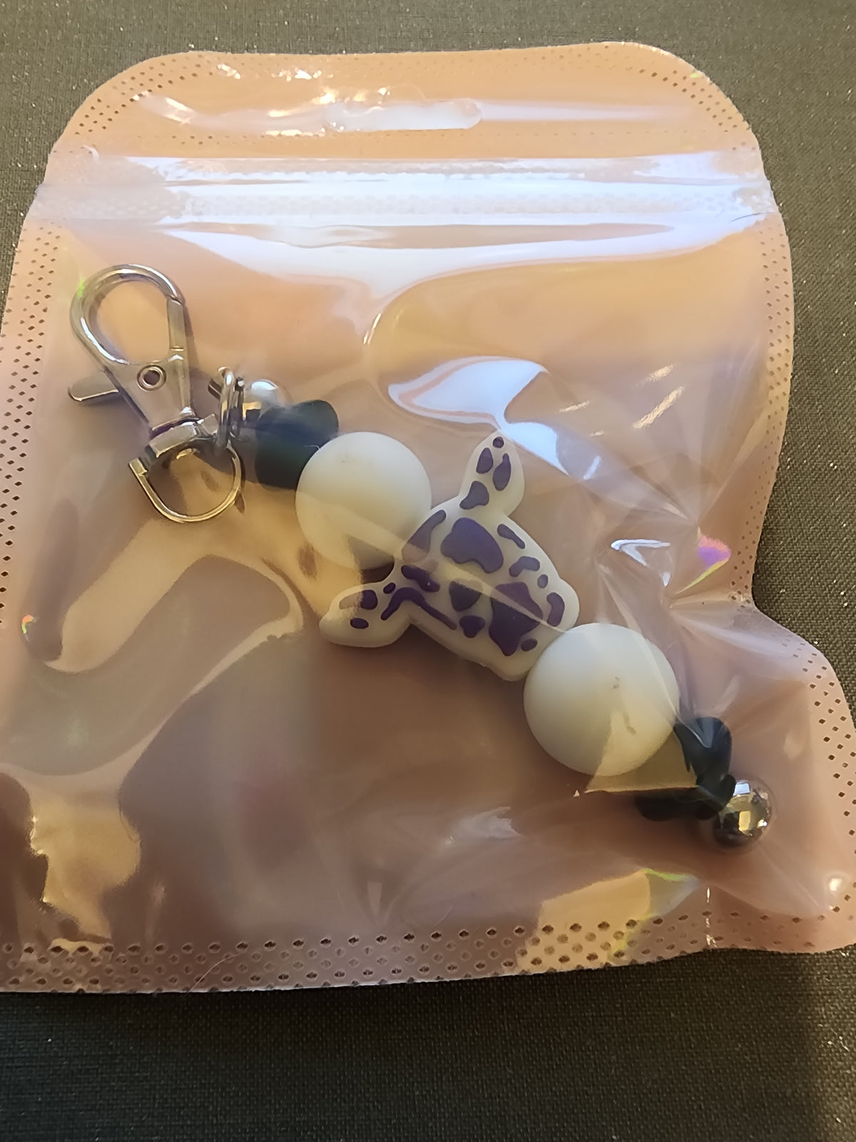 Purple and white cow keychain